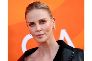 Charlize Theron Stuns in Mini Skirt at Paris Fashion Week